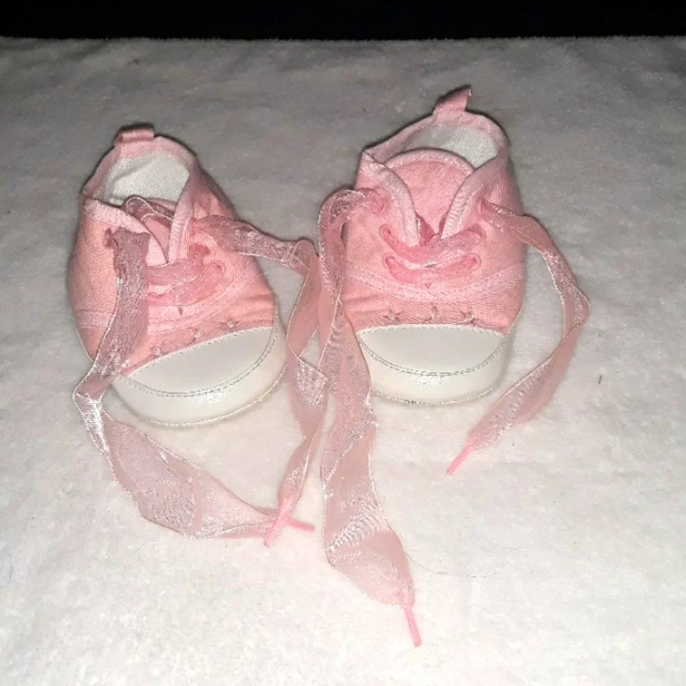 Pink baby sneakers with moon and star beaded accents and fun laces